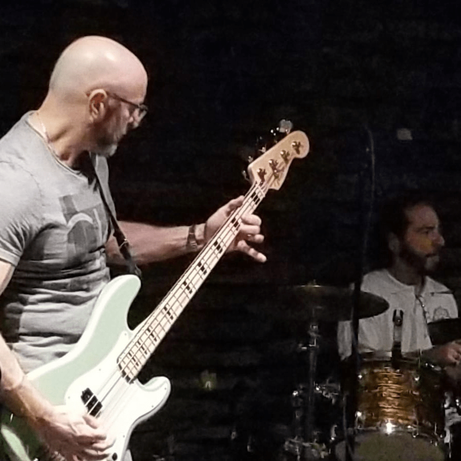 CJ is playing the bass guitar on stage in Fort Lauderdale, FL