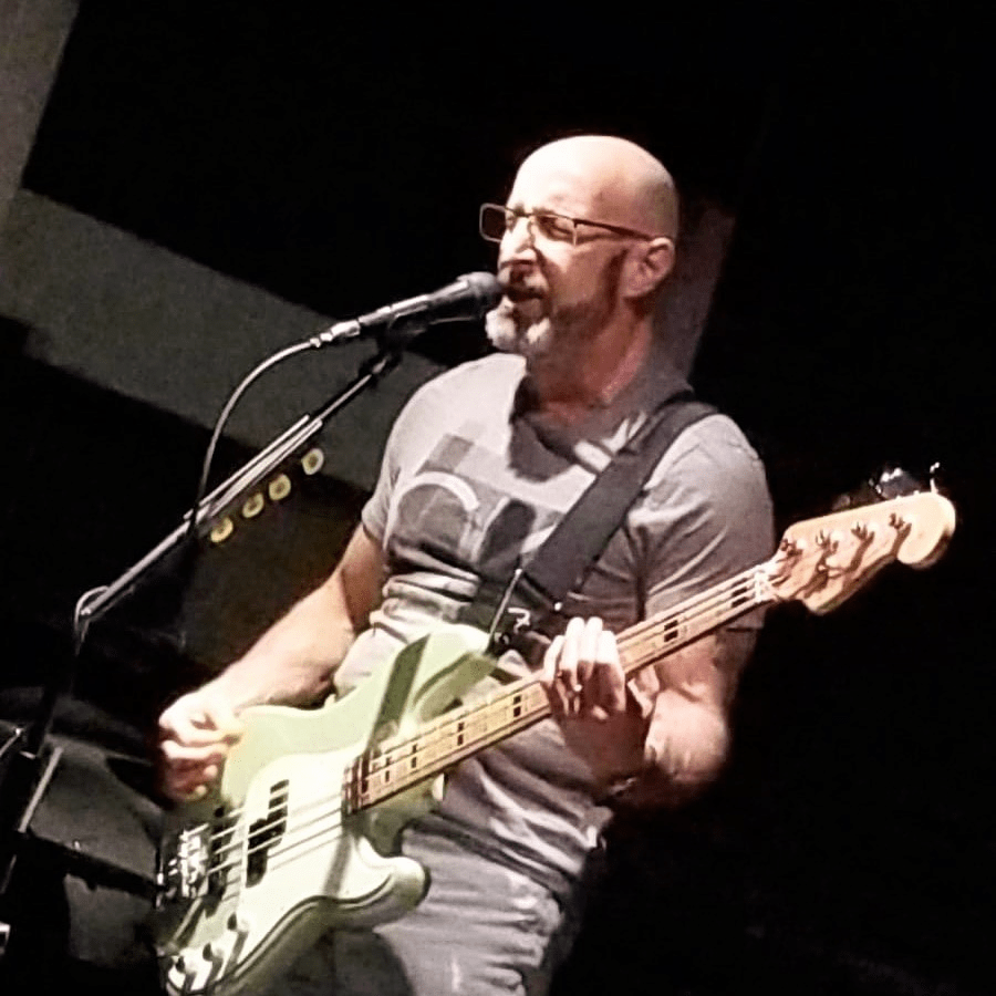 CJ playing bass guitar on stage in Fort Lauderdale, FL